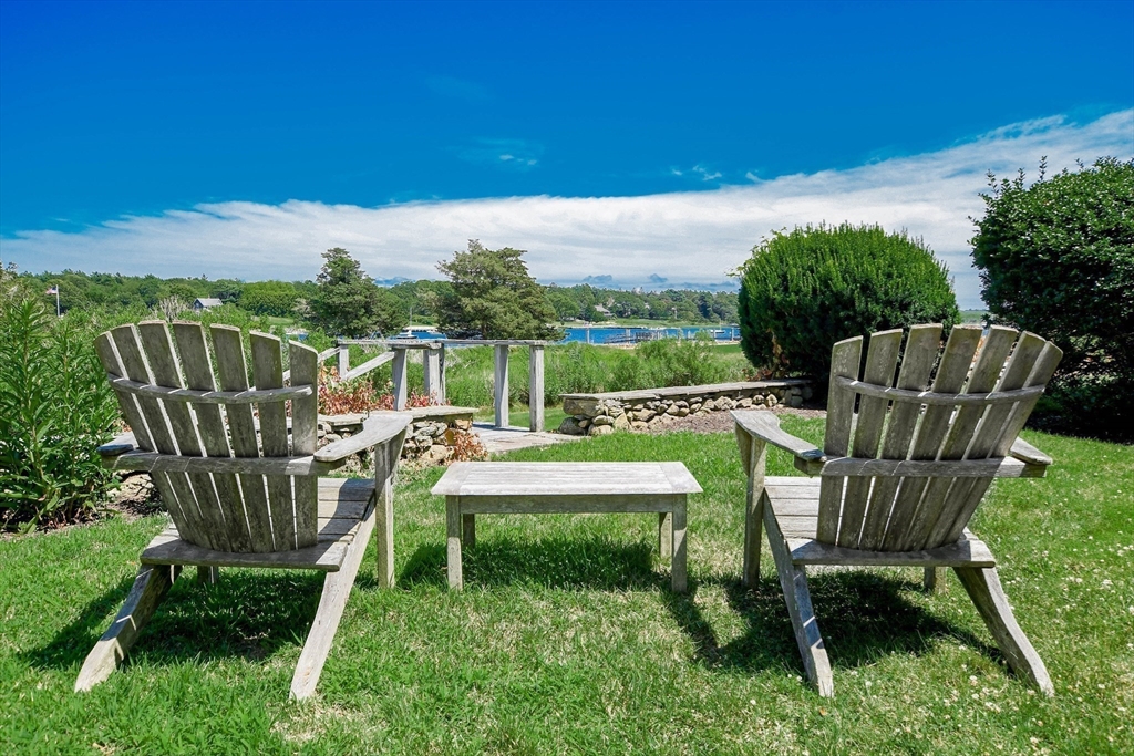 160 Allens Point Road Marion, MA 02738 - Photo 15 of 31 a view of a chair and tables in the back yard of the house