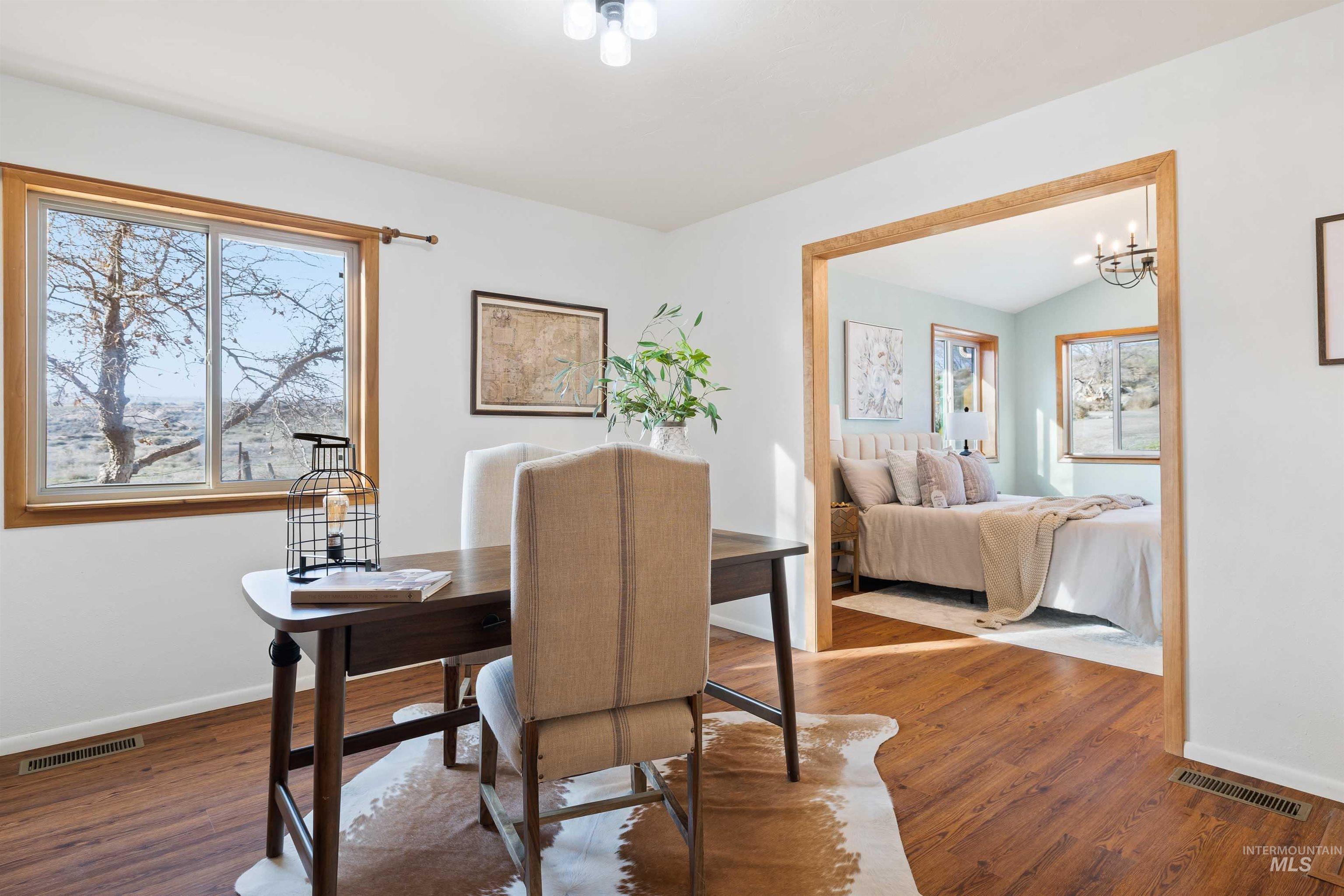 853 Pottery Road Bliss, ID 83314 - Photo 14 of 50 Dining space featuring dark wood finished floors and a chandelier