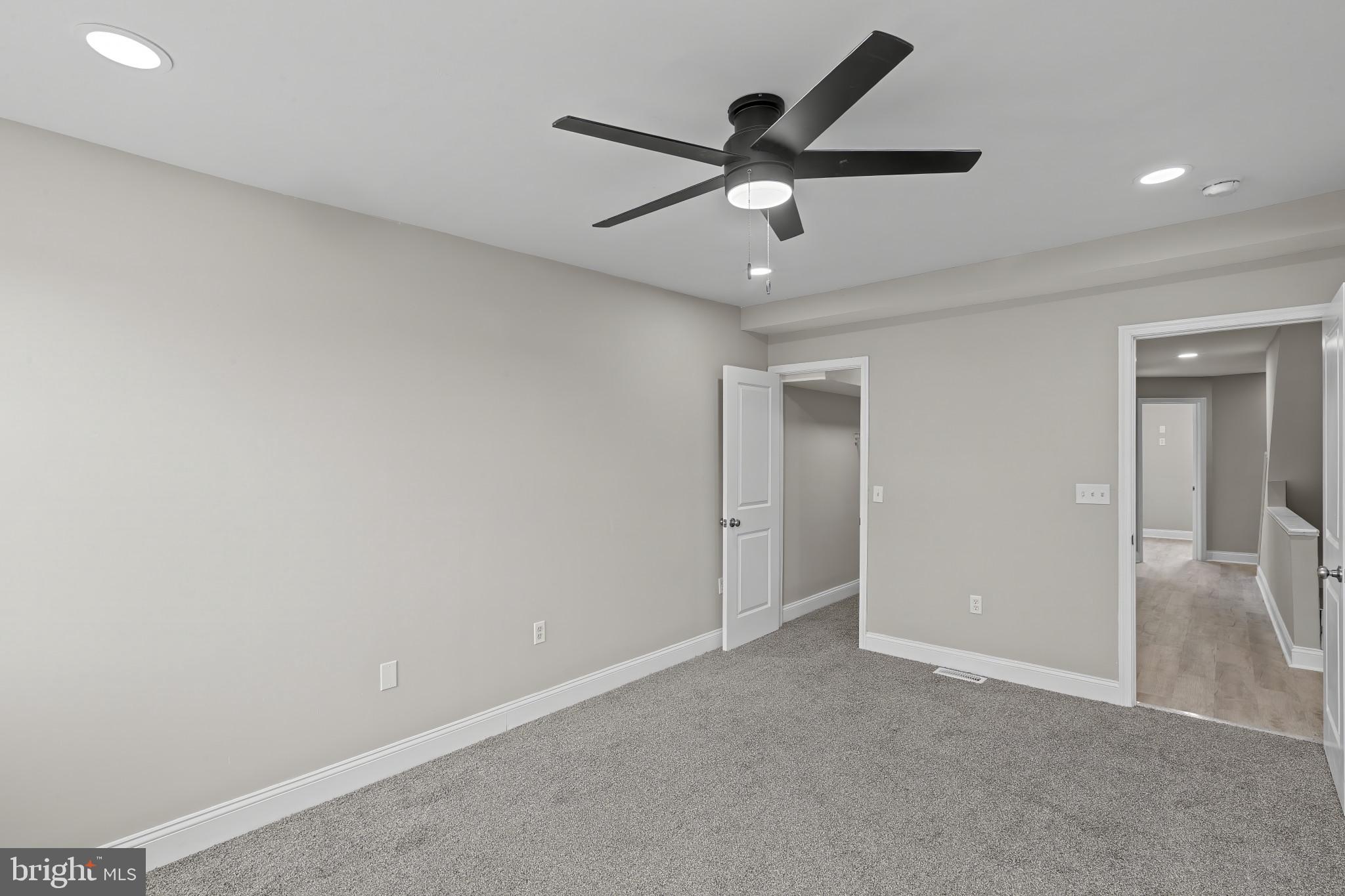 1525 West Pratt Street Baltimore, MD 21223 - Photo 19 of 40 an empty room with a ceiling fan and a ceiling fan