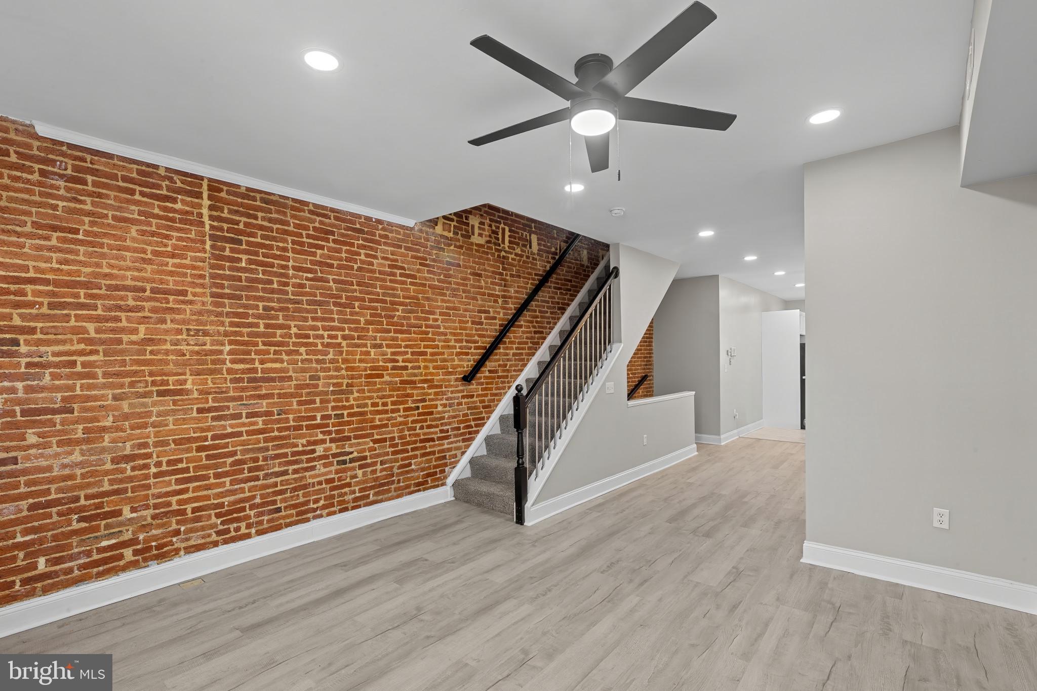 1525 West Pratt Street Baltimore, MD 21223 - Photo 3 of 40 a view of an empty room with wooden floor