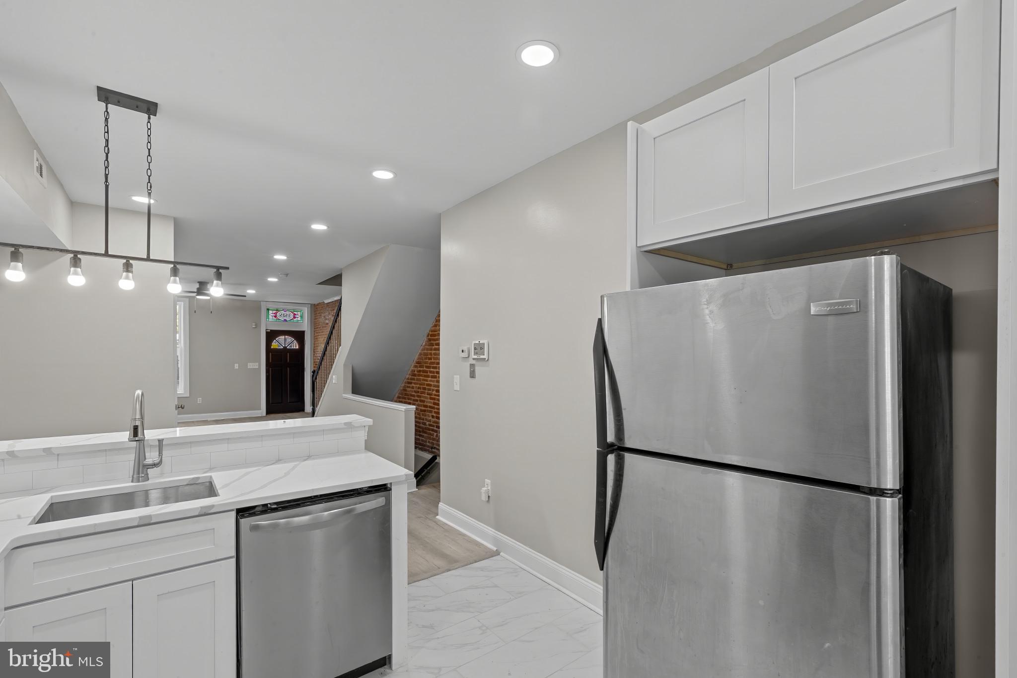 1525 West Pratt Street Baltimore, MD 21223 - Photo 9 of 40 a view of a kitchen with a sink and refrigerator