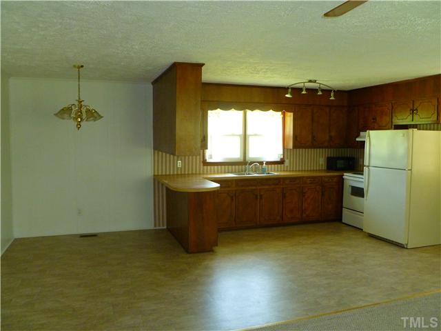 105 Circle B Farm Road Rougemont, NC 27572 - Photo 11 of 22 a kitchen with a refrigerator and a more cabinets