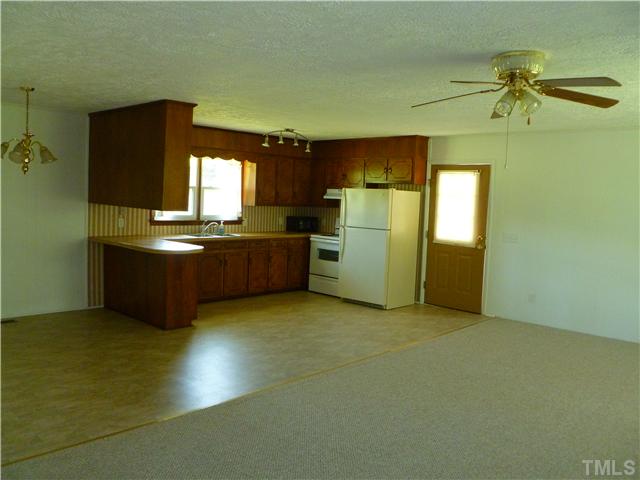 105 Circle B Farm Road Rougemont, NC 27572 - Photo 14 of 22 a view of a kitchen with a sink cabinet and a living room
