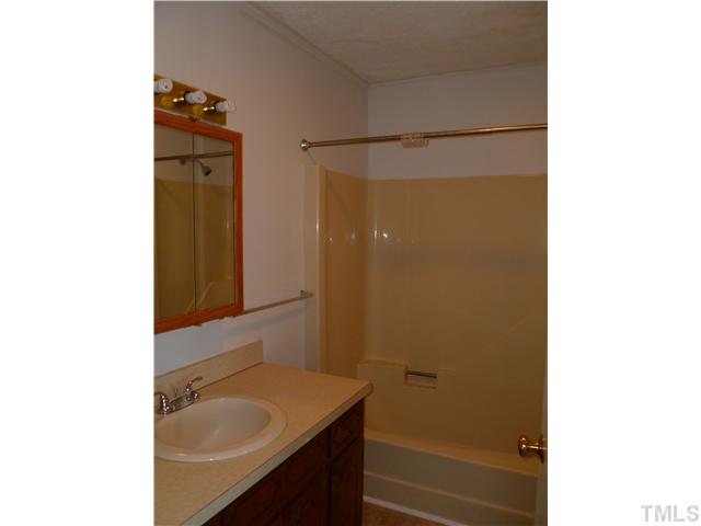 105 Circle B Farm Road Rougemont, NC 27572 - Photo 16 of 22 a bathroom with a granite countertop sink shower and a mirror