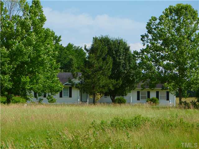 105 Circle B Farm Road Rougemont, NC 27572 - Photo 22 of 22 a view of house with lush green forest
