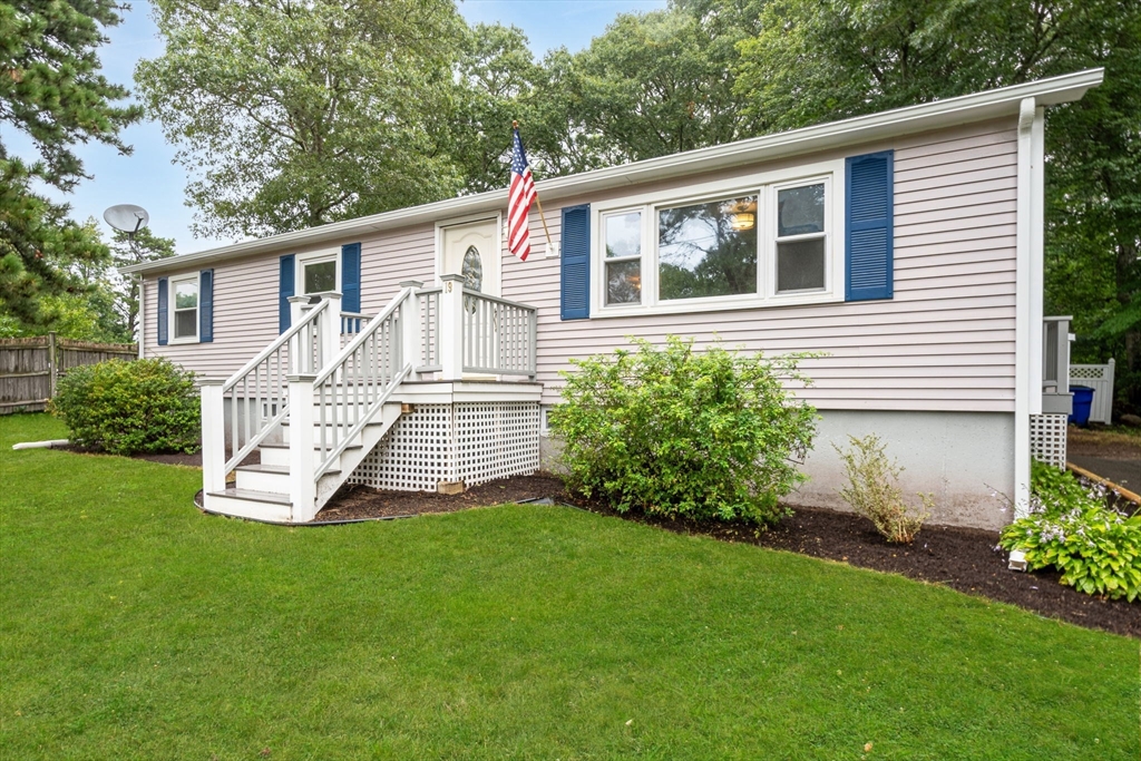 a view of a house with a yard and a garden