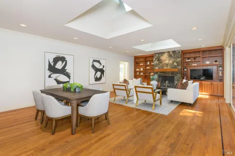 a living room with furniture a chandelier and a large mirror