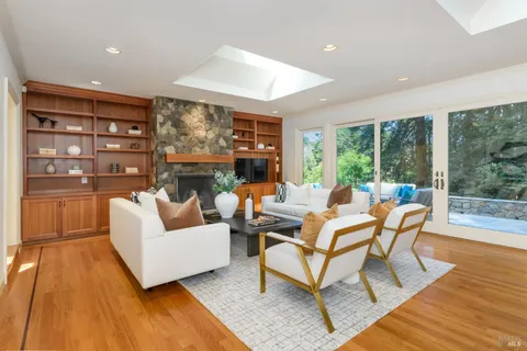 a living room with fireplace furniture and a large window