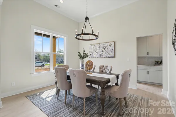 a living room with furniture a fireplace and a chandelier
