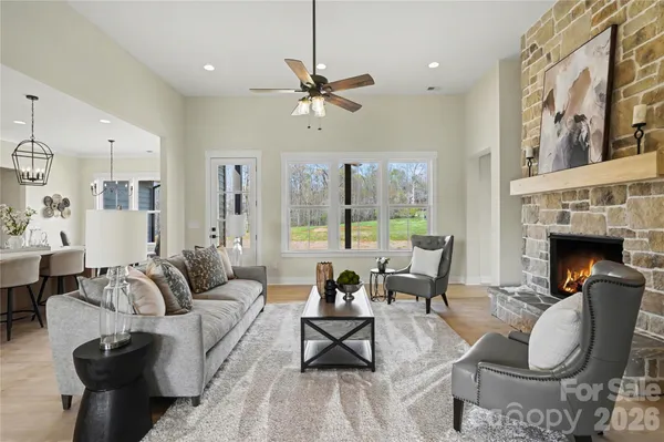 a view of dining table chairs wooden floor and kitchen view