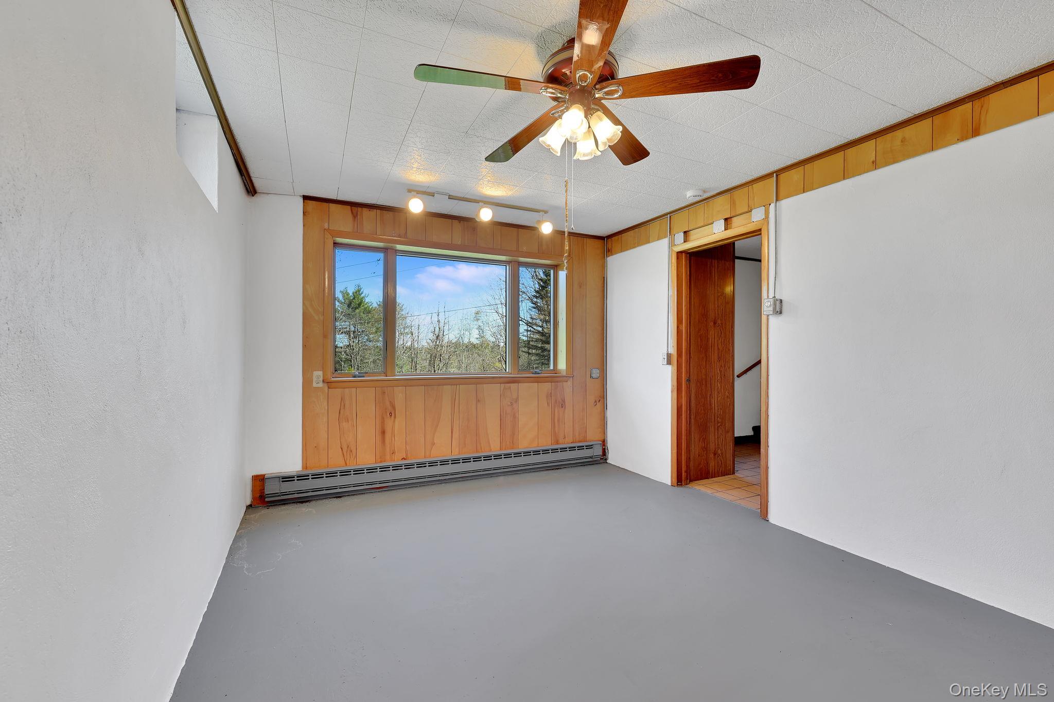 208 Shortcut Road Cochecton, NY 12726 - Photo 33 of 46 an empty room with windows and fan