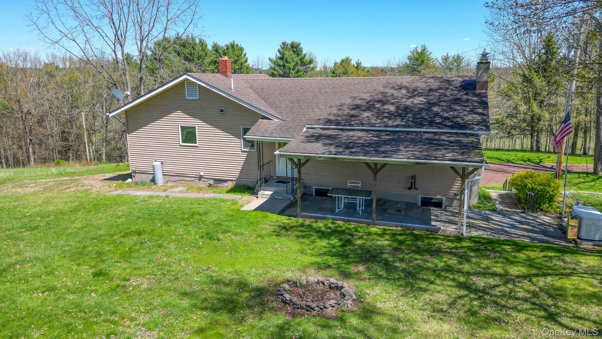 208 Shortcut Road Cochecton, NY 12726 - Photo 35 of 46 a view of a house with a yard and sitting area