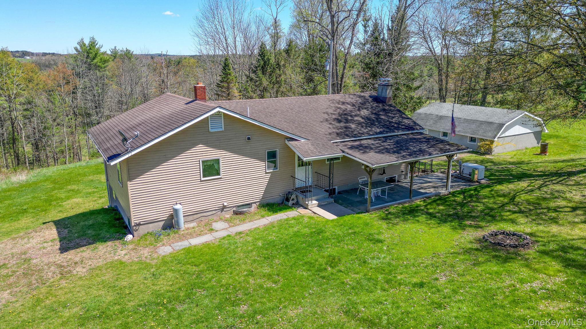 208 Shortcut Road Cochecton, NY 12726 - Photo 38 of 46 a view of house with backyard and outdoor seating