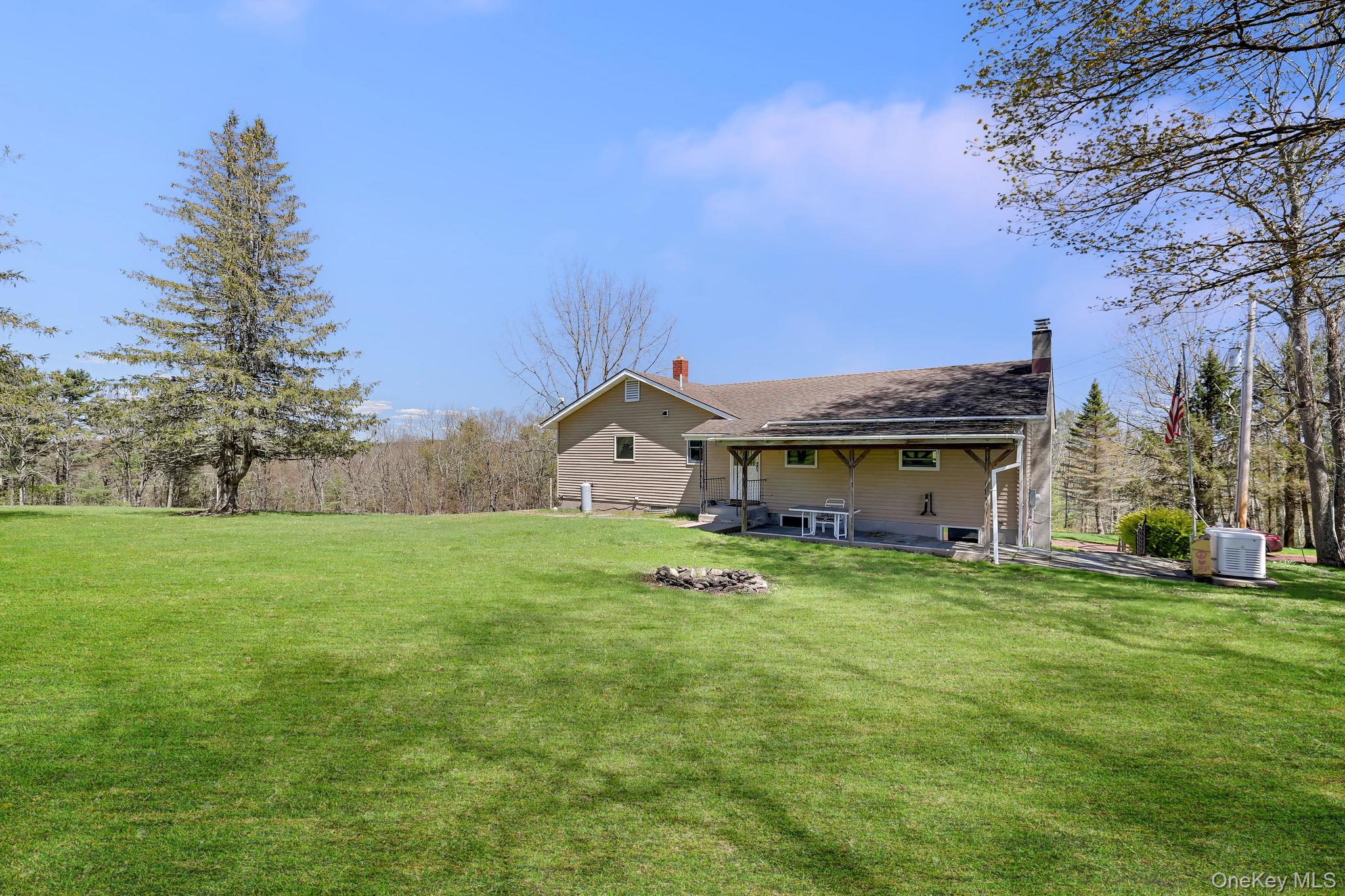 208 Shortcut Road Cochecton, NY 12726 - Photo 39 of 46 a house with huge green field in front of it