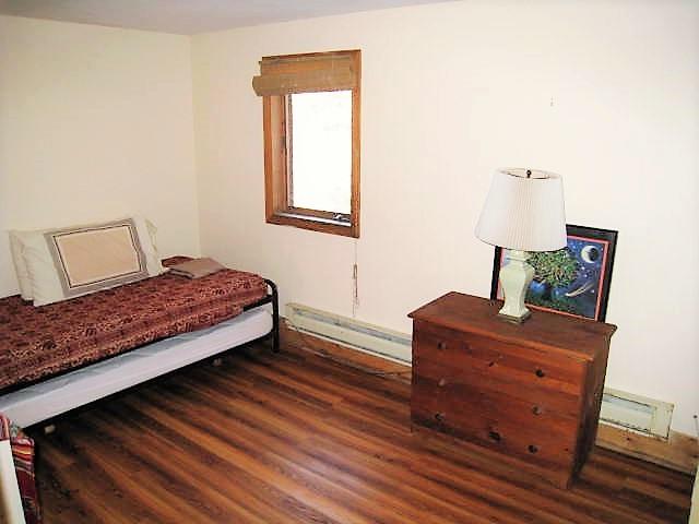 10 Pine Valley Road Wellfleet, MA 02667 - Photo 16 of 27 a bedroom with a bed window and wooden floor