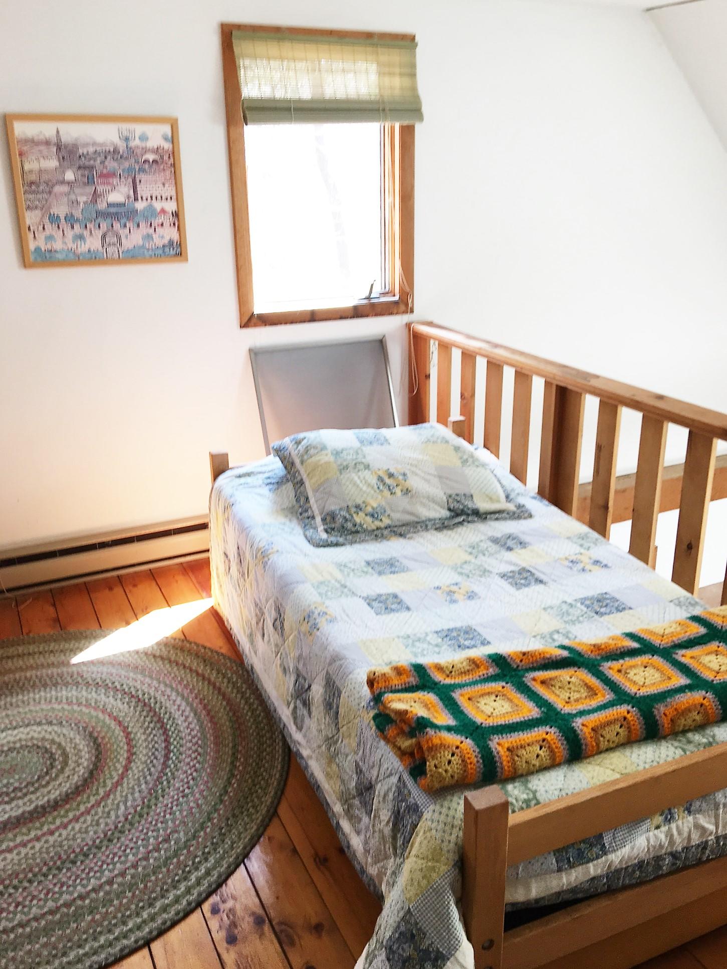 10 Pine Valley Road Wellfleet, MA 02667 - Photo 19 of 27 a bedroom with a bed and wooden floor