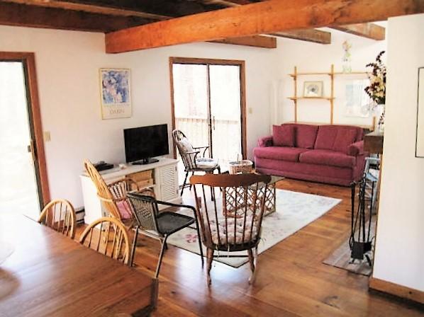 10 Pine Valley Road Wellfleet, MA 02667 - Photo 27 of 27 a living room with furniture a flat screen tv and a floor to ceiling window