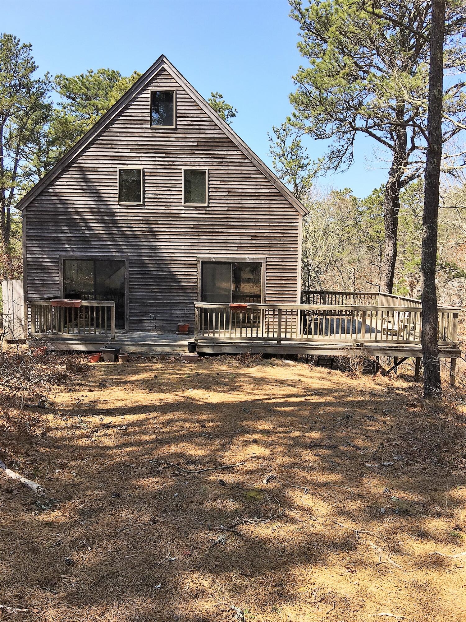 10 Pine Valley Road Wellfleet, MA 02667 - Photo 3 of 27 a front view of a house with a yard