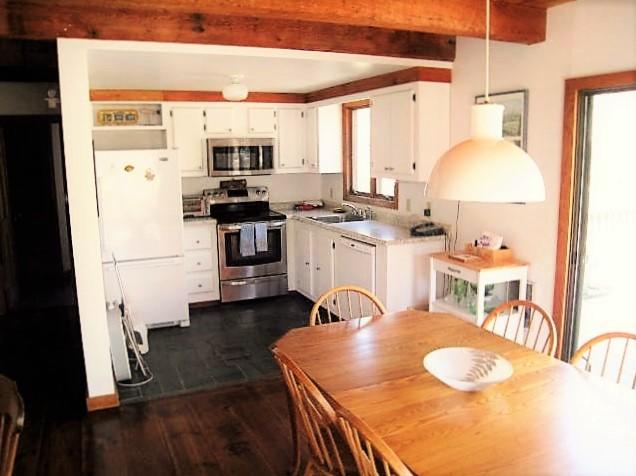 10 Pine Valley Road Wellfleet, MA 02667 - Photo 9 of 27 a kitchen with a table chairs stove and refrigerator