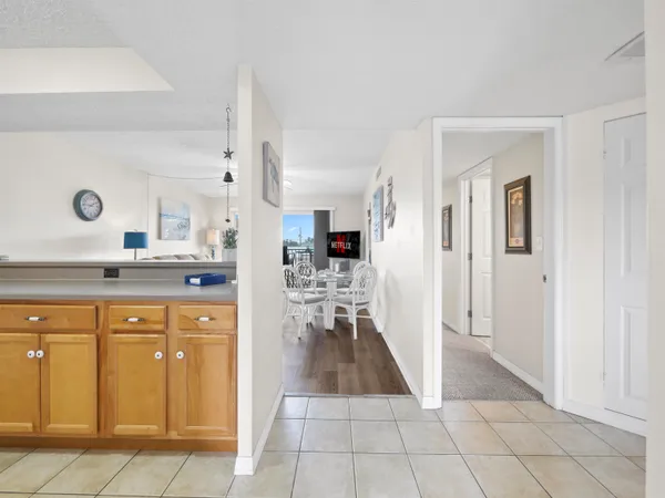 a view of a kitchen with kitchen island cabinets and refrigerator