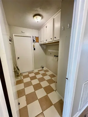 a bathroom with a black and white checkered floor