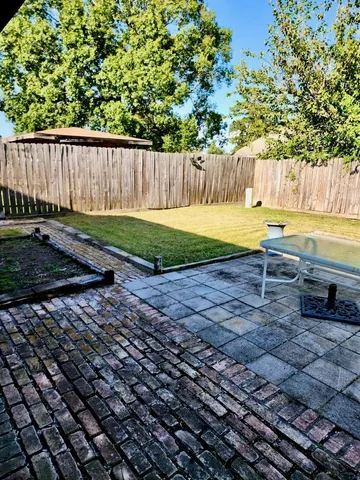a view of a backyard with swimming pool