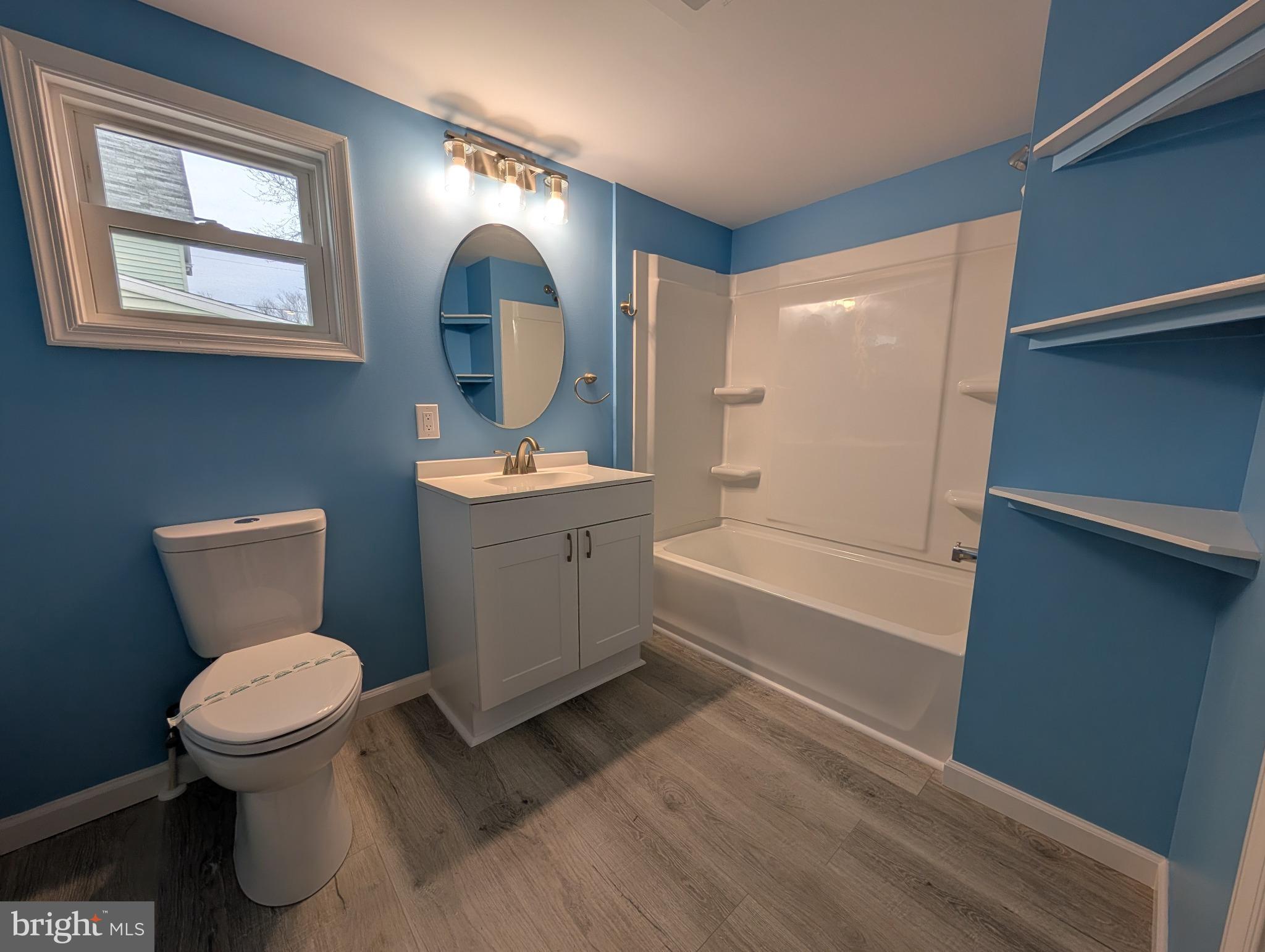 703 Madison Street Salisbury, MD 21804 - Photo 11 of 22 a bathroom with a toilet sink and mirror