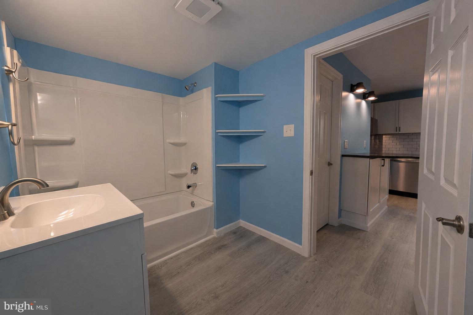 703 Madison Street Salisbury, MD 21804 - Photo 12 of 22 a bathroom with a bathtub and a sink