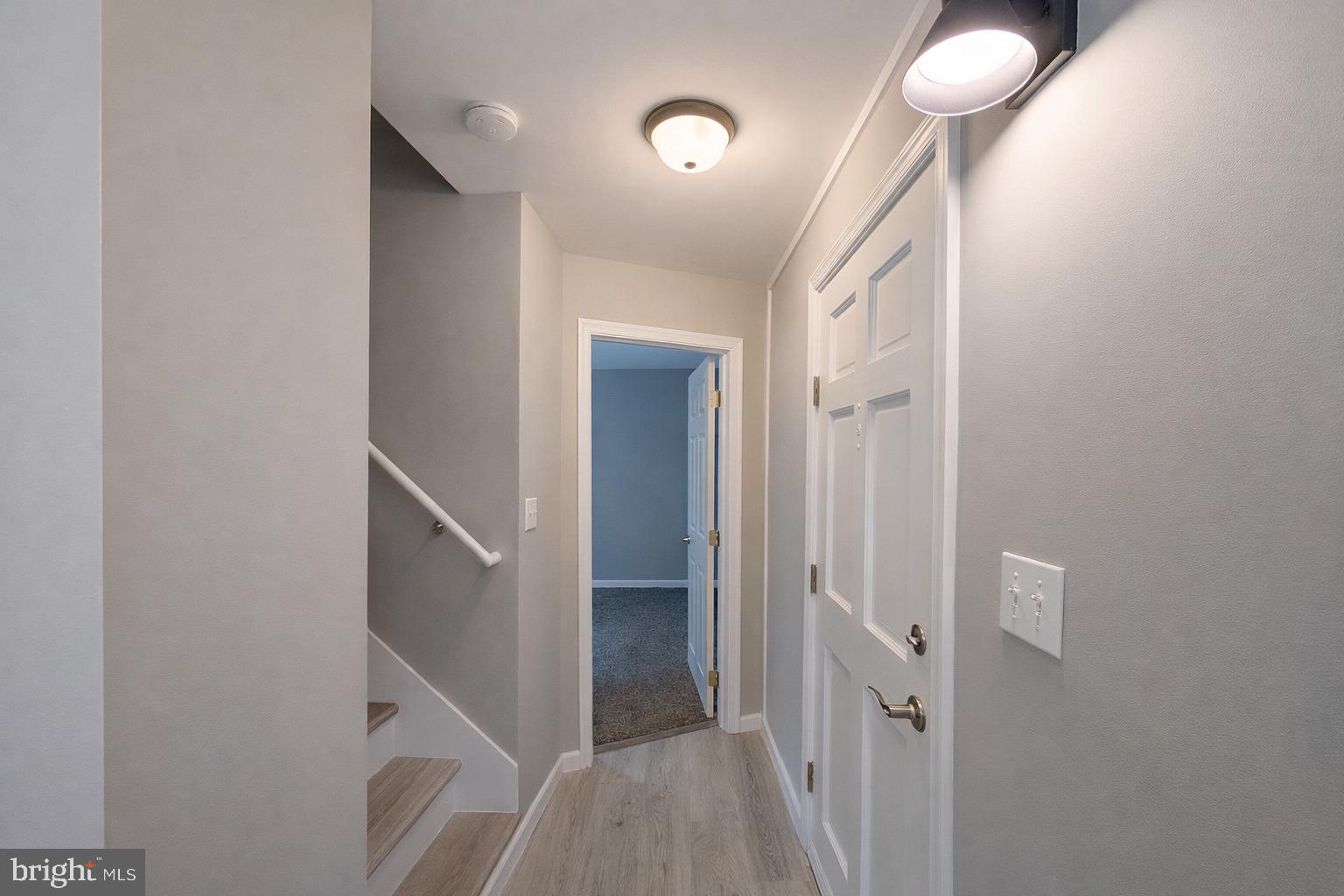703 Madison Street Salisbury, MD 21804 - Photo 14 of 22 a view of a hallway with a white walls and a chandelier