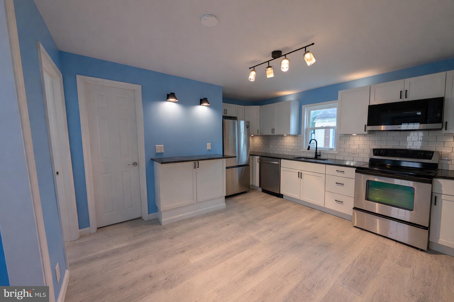 703 Madison Street Salisbury, MD 21804 - Photo 7 of 22 a kitchen with a refrigerator and a stove top oven