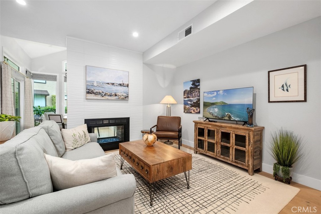 26 Sunbridge Place Dana Point, CA 92629 - Photo 4 of 15 a living room with furniture a flat screen tv and a fireplace