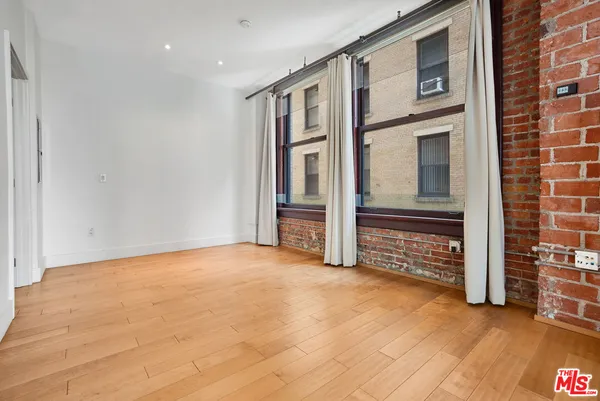 a view of an empty room with a fireplace
