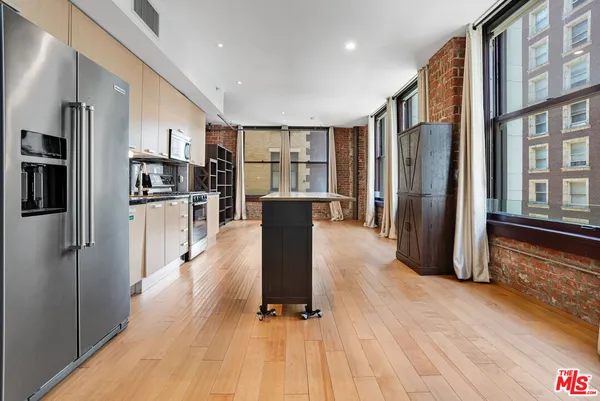 a kitchen with stainless steel appliances granite countertop a refrigerator oven and a refrigerator