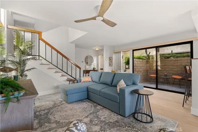 a living room with furniture and a floor to ceiling window
