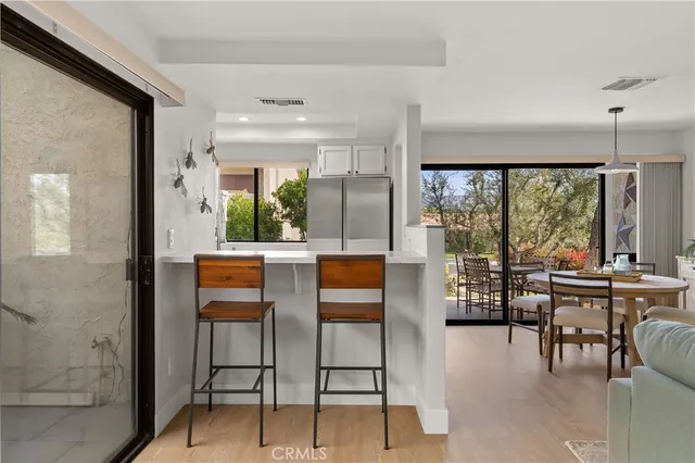 a kitchen with stainless steel appliances granite countertop a refrigerator and a stove top oven