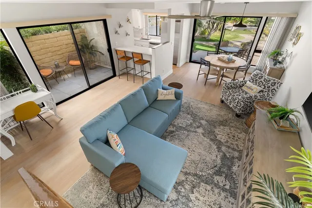 a view of staircase with lots of frames on wall and a window