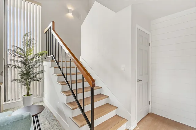 a spacious bedroom with two beds and painting on the wall