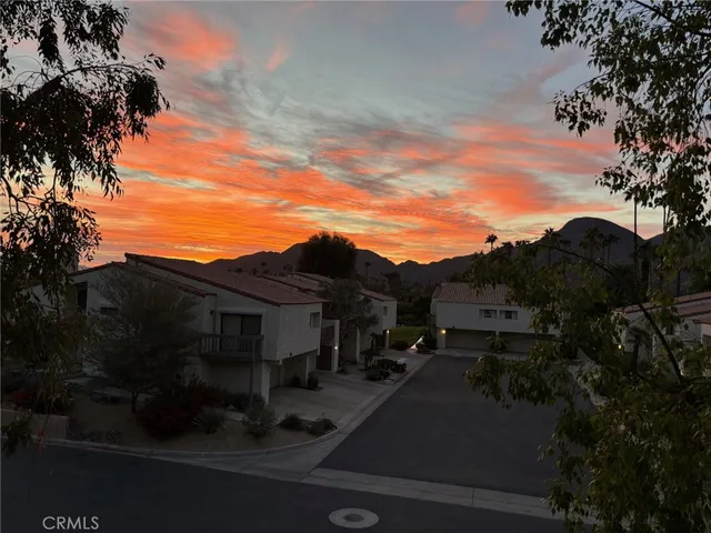 a bedroom with a bed a mirror and lamp