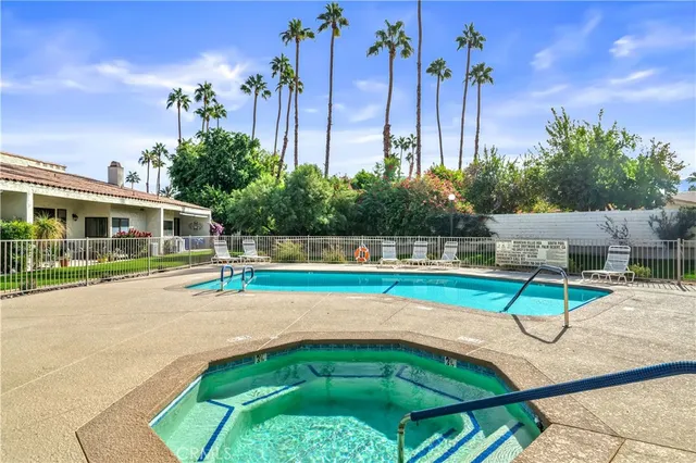 an aerial view of residential houses with outdoor space and parking