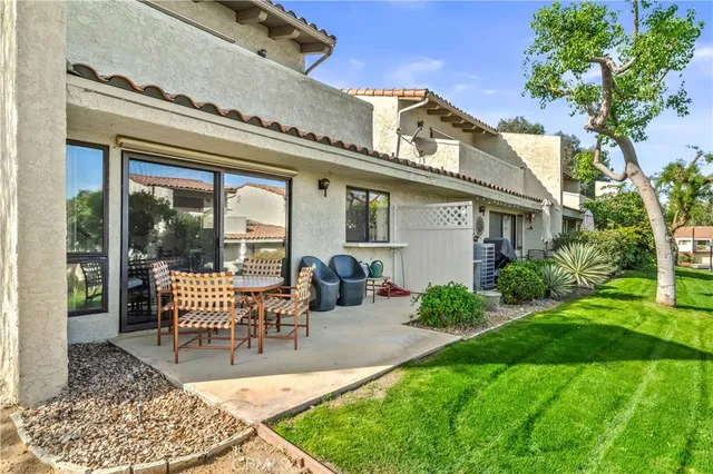 a view of a house with backyard porch and sitting area