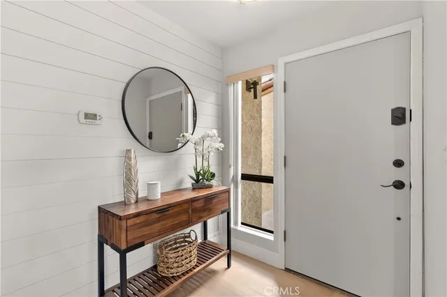 a room with a mirror and a wooden door