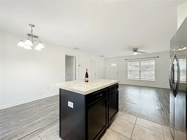 a kitchen with a sink and chandelier