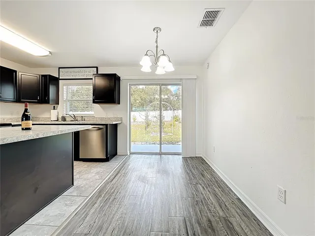 a kitchen with kitchen island granite countertop a sink appliances cabinets and a counter top space