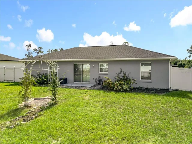 a view of a house with backyard and porch