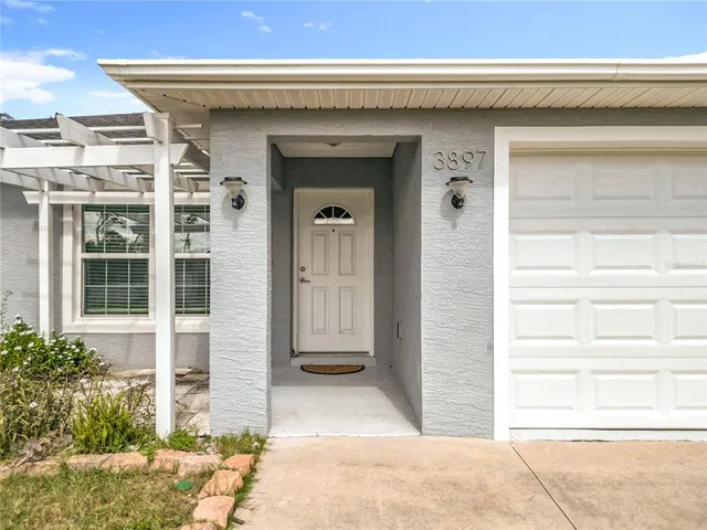 front view of a house with a potted plant