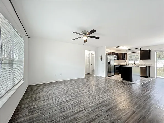 a view of a kitchen with stove and wooden floor