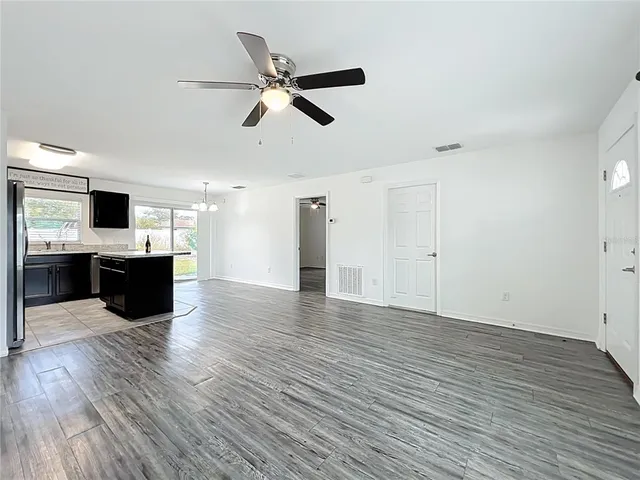 a view of kitchen with sink and refrigerator