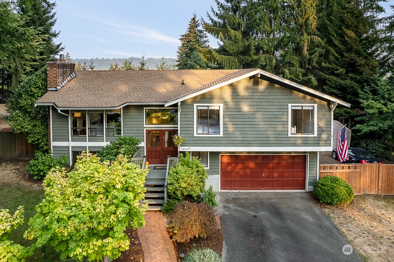 18434 129th Lane Northeast Bothell, WA 98011 - Photo 1 of 33 a front view of a house with a yard and garage
