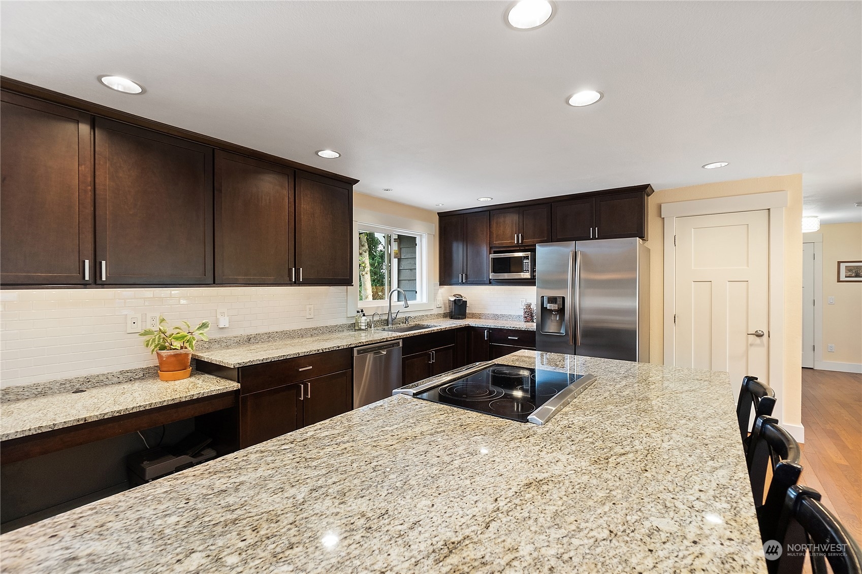 18434 129th Lane Northeast Bothell, WA 98011 - Photo 7 of 33 a kitchen with granite countertop a sink appliances and cabinets