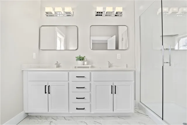 a bathroom with double vanity sink two mirror and